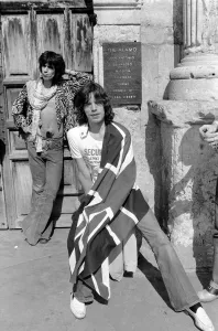 00291 Prints: Mick Jagger (with Union Jack flag) and his Rolling Stones band stand at the famous Alamo