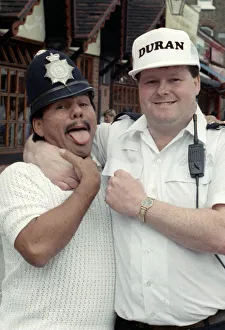 Middle Weight Boxer Roberto Duran seen here in the strong arm of the law as he hams it up