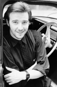 Midge Ure singer pop group Ultravox music sitting in car arms folded circa 1985