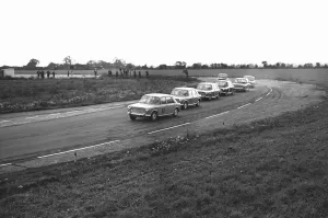 Queue Prints: Mike Parkes No 87 leads the competitors in the Molyslip Morris 1100 race at Snetterton