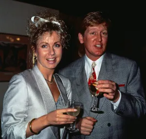 Mike Smith DJ disc jockey TV presenter with Sarah Greene holding glasses of champagne
