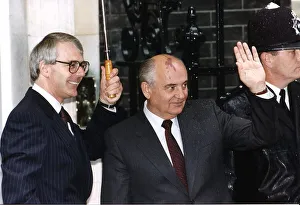 Mikhail Gorbachev stands with John Major under umbrella outside 10 Downing Street 1991