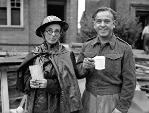 00444 Prints: Military Personal take a break from inspecting Bomb damage after Air Raid, Solihull