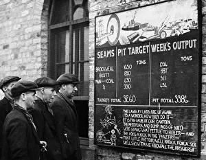 Miners at Langley Park Colliery on their way to work stop for a glance at their record
