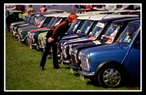 Classic Prints: Mini car August 1999 Woman looking at blue Minis Mini cars are at Silverston for 40th