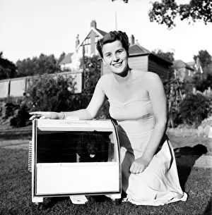 00010 Prints: Miniature French Poodle seen here in her mobile kennel with mistress Miss Barbara