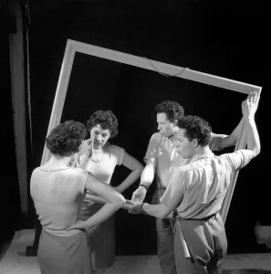 Mirror image: A couple argue in front of a mirror. 1958