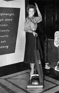 Appliances Prints: Miss Doreen Haines of Kensington. poses with a vacuum cleaner at Fillerys store