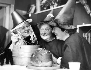 00107 Prints: Mixing up a strong brew in their cauldron, three witches at the Halloween party held by