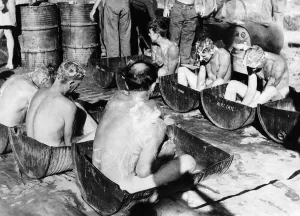 Mobile bath unit at Sadaung in Burma provides sliced oil drums filled with hot water