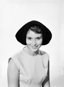 Model Ann Cave wearing a collection of spring and summer hats. Circa 1962