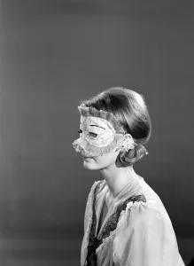 Model Dawn Chapman wearing face mask to aid her in getting a good nights sleep. 1962