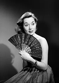Model with fan in strapless dress. Model with fan in strapless dress. Circa 1964