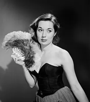 Model with fan in strapless dress. Model with fan in strapless dress. Circa 1964