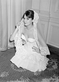 Model Helga Allgoaoer modelling a dress designed by Hans Ostergard - a white fitted
