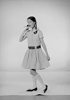 Model Jennifer Goddard. Brown-haired girl in checkered dress with pig tails