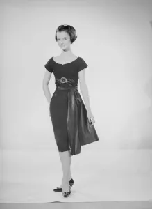 Model Jennifer Goddard. Young woman in short dressy black dress