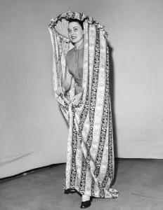Changing Room Prints: Model Julie Wilson wearing a printed mobile changing curtain June 1951