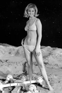 Model June Cooper poses for pictures with a backdrop designed as the surface of the moon