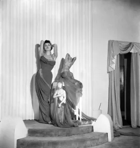00011 Prints: Model June Sweetzer poses wearing an elegant long dress. September 1952 C4772