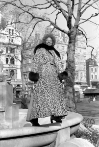 Model Lorne Lesley wearing a long leopard skin coat with fur collar February 1975