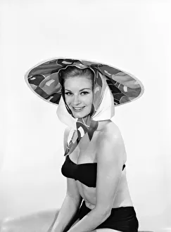 Model Margaret Lorraine wearing beach cushion hat. August 1962
