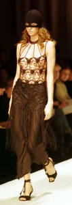 Mask Prints: A model models a crochet top and ski mask March 1999 at the Moschino fashion show