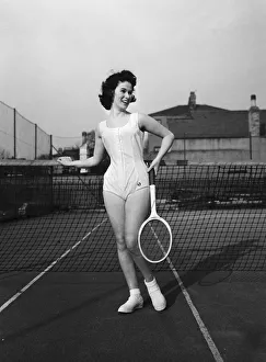 Model Norma Parnell wearing a white cotton button romper with camisole top