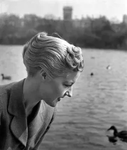 00038 Prints: Model Pat Walker, 25, with her Duck'hair-do watching ducks swimming in St
