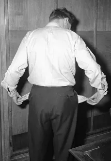 00292 Prints: Model poses to illustrate a luck of funds. 29th April 1954