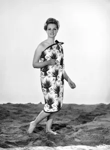 Model Roma Reeves wearing beach toga that doubles as a beach towel. May 1962