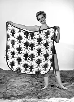 Model Roma Reeves wearing beach toga that doubles as a beach towel. May 1962