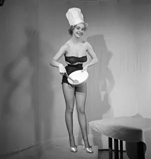Model seen here in a chef hats making pancake mix, Tuesday 1st March 1960