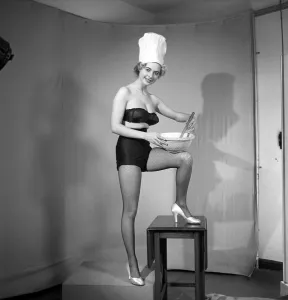 Model seen here in a chef hats making pancake mix, Tuesday 1st March 1960