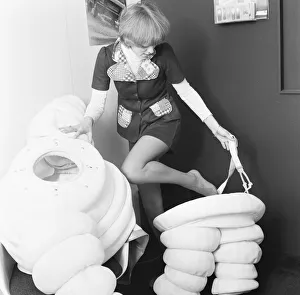 Advertising Prints: Model seen here putting on a Michelin man costume at the 1972 Motor Show at Earls Court