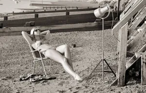 Sun Bathing Prints: A model sunbathing under a UV lamp on the beach at Cleethorpes November 1967