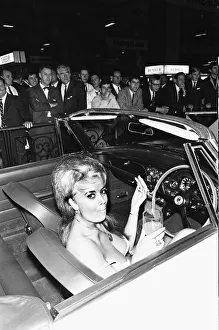Model takes ker linch break from draping over cars at the 1966 London Motor Show 18th