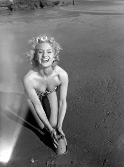 A model wearing a bikini as she enjoys the sun on the beach at Hove March 1959