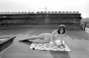 A model wearing a bikini as she subathes on a rooftop on Kings Road in Chelsea, London