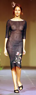 A model wearing a see through black dress October 1998 with flower pattern detail