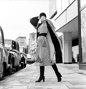 Model wearing a checkered and patterned dress with matching skirt