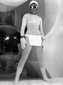 Boots And Shoes Prints: Model wearing knitted all in one suit with joke goggles and woolly hat
