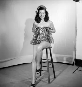 Model wearing leopard skin mini dress and matching muff. 1964