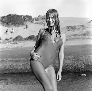 Swimsuit Prints: Model wearing a one piece swimsuit as she poses on a beach in Africa April 1975