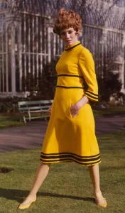 Yellow Prints: A model wearing a yellow tweed maxi dress designed by Emor, March 1968