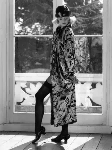 Our model wears a black and silver coat, an original from the television series