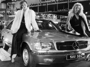 Glamourous Prints: Two models draped over the bonnet of the new Mercedes 500 Sec at the 1982 Motor Show