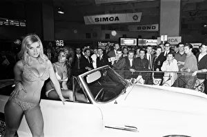 Show Prints: Models drapped over cars at the London Motor Show 18th October 1966