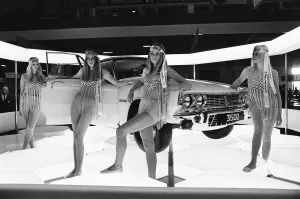 Models drapped over A Rover motor car on the Dunlop Tyre stand at the 1969 Motor Show