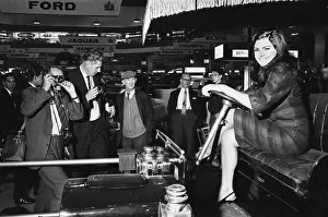 Happy Smiling Prints: Models drapped over a vintage car at the British International Motor Show in London 19th